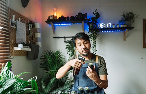Florist prices plants in his home