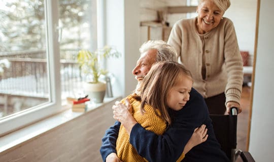 Grandparents greet child in home