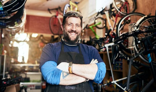 Employee smiling at bike repair shop