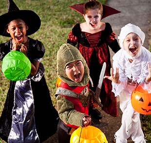 Four kids dressed up for Halloween