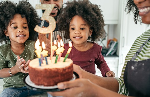 Family of four celebrating birthday with twins